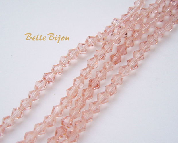 Cristale biconice de aprox 4 mm roz pal  (10 bucati), imitatie Swarovski crystal light peach