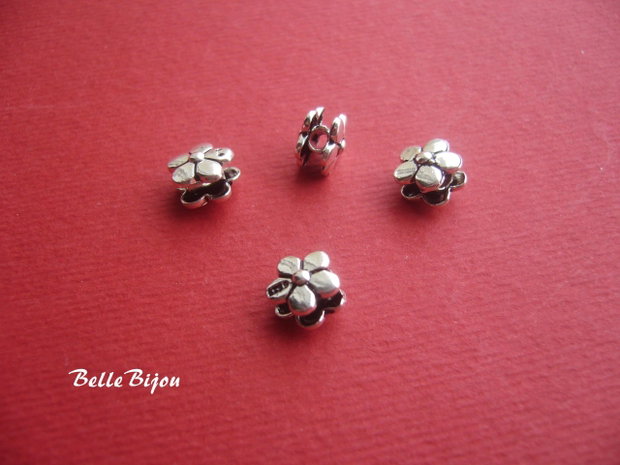 Distantier din 2 floricele cu 5 petale prinse pe un tub aprox 6x8 mm