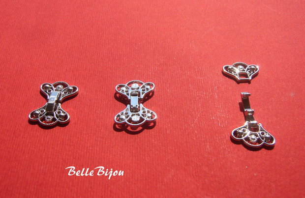 Inchizatoare ornamentala finisaj argintiu rodiat aprox 16x22 mm