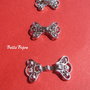 Inchizatoare ornamentala finisaj argintiu rodiat aprox 16x22 mm
