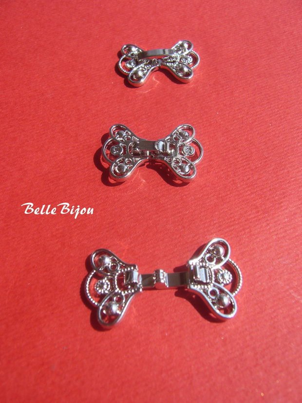 Inchizatoare ornamentala finisaj argintiu rodiat aprox 16x22 mm