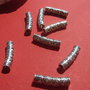 Tub argintiu usor arcuit cu flori mari aprox 6x26 mm