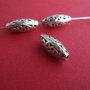 Margele medii metalice oval - alungit cu model in valuri aprox 7x19 mm