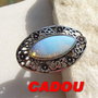 CADOU.... Inel reglabil din metal argintiu cu cabochon din opalit
