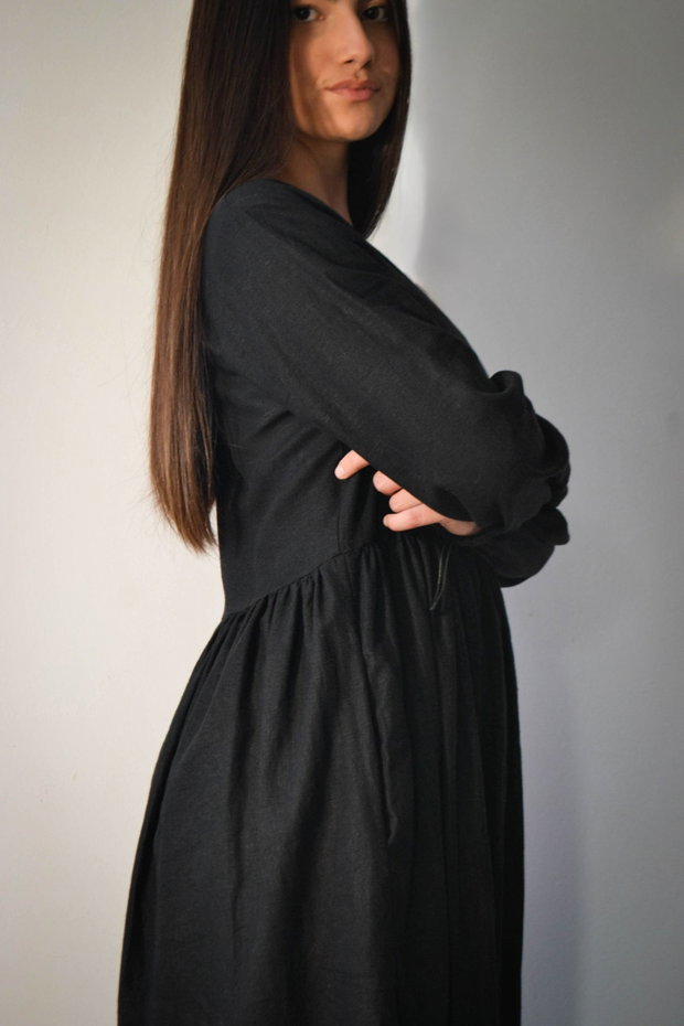 Rochie midi din in negru, petrecută în partea de sus.