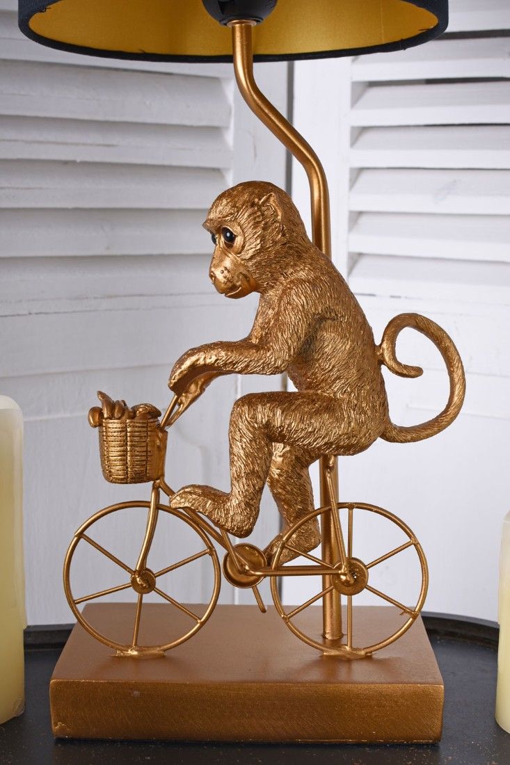 Lampa de masa cu o maimuta cu bicicleta