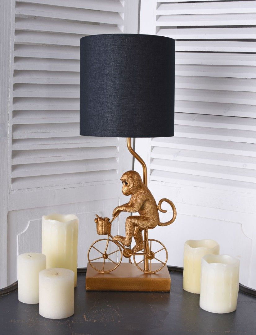 Lampa de masa cu o maimuta cu bicicleta