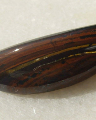 Iron tiger eye cabochon aprox 32.5x11x6.5 mm